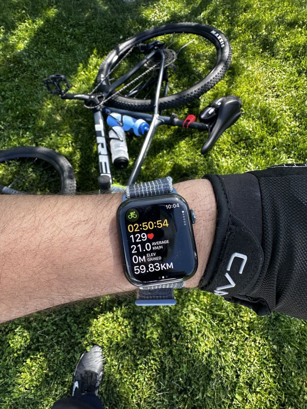 Apple Watch showing ride stats — 2:50:54, 59.83 km, 129 BPM